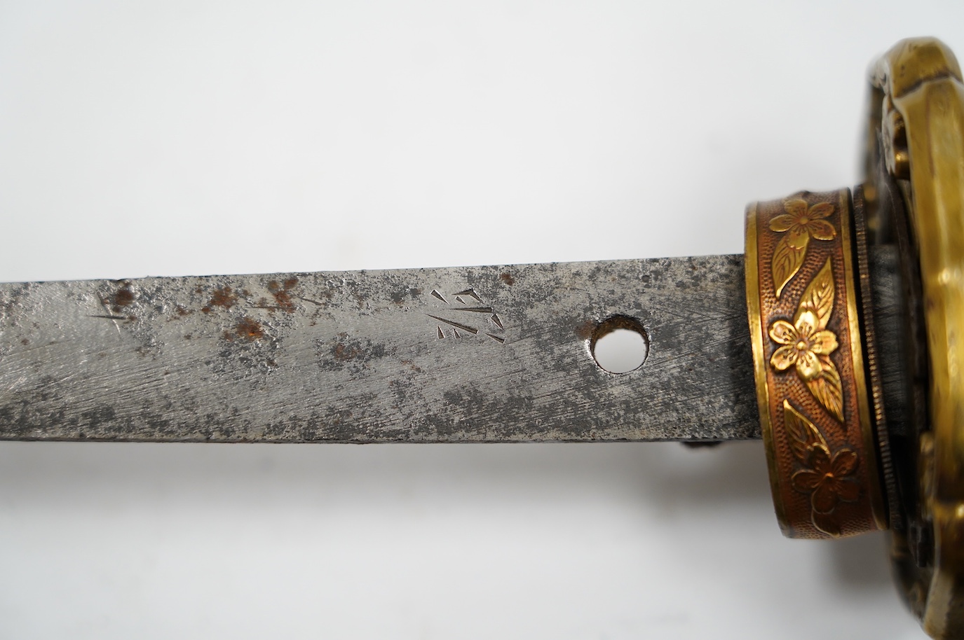 A Japanese WWII army officer’s sword Katana, blade 57.9cm, signed and dated with Seki Arsenal stamp, retaining good polish, in shin gunto mounts with leather combat cover on hilt and scabbard, the latter with plate stamp